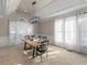 Cozy dining room with modern chandelier and large windows providing natural light for Gathering meals and gatherings at 152 Vinings Lake Ct, Mableton, GA 30126