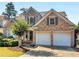 Beautiful two-story home with brick facade, well maintained lawn, and two-car garage at 152 Vinings Lake Ct, Mableton, GA 30126