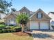 Attractive two-story home featuring a brick facade, manicured lawn and a convenient two-car garage at 152 Vinings Lake Ct, Mableton, GA 30126