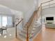 Bright foyer with hardwood floors leading to staircase and a living area with fireplace at 152 Vinings Lake Ct, Mableton, GA 30126
