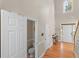 Spacious foyer with hardwood floors, high ceilings, a half bath, and entry to the main house at 152 Vinings Lake Ct, Mableton, GA 30126