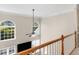 A bright two-story foyer with arched windows and a ceiling fan at 152 Vinings Lake Ct, Mableton, GA 30126