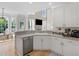 Bright kitchen with stainless steel dishwasher, white cabinets, and hardwood floors at 152 Vinings Lake Ct, Mableton, GA 30126