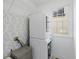 Convenient laundry room with modern washer and dryer, shelving, and stylish wallpaper, making chores a breeze at 152 Vinings Lake Ct, Mableton, GA 30126
