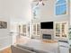 Open-concept living room with fireplace, large windows, and view into the breakfast area at 152 Vinings Lake Ct, Mableton, GA 30126