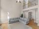 Spacious living room with a cozy gray couch, carpet, and high ceilings at 152 Vinings Lake Ct, Mableton, GA 30126