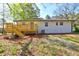Backyard view of a brick home, featuring a wooden deck, stairs, and green space at 2248 Doris Dr, Decatur, GA 30034