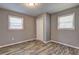 Cozy bedroom featuring two windows, stylish floors, and a white closet door at 2248 Doris Dr, Decatur, GA 30034
