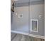 Laundry room with painted grey walls, hookups, modern fixtures, and tile floors at 2248 Doris Dr, Decatur, GA 30034