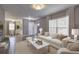 A bright living room showcasing modern decor, including a plush sofa, and a view into the dining area at 2248 Doris Dr, Decatur, GA 30034