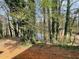 Backyard view of a lake through a forest at 1374 To Lani Farm Rd, Stone Mountain, GA 30083