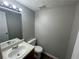 Half-bathroom featuring a vanity and a mirror at 1374 To Lani Farm Rd, Stone Mountain, GA 30083