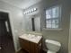 Well-lit bathroom featuring a double sink vanity and a large mirror at 1374 To Lani Farm Rd, Stone Mountain, GA 30083