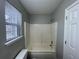 Clean bathroom with a shower-tub combo and a window for natural light at 1374 To Lani Farm Rd, Stone Mountain, GA 30083