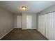 Bedroom features neutral walls, plush carpet, and a closet with double doors at 1374 To Lani Farm Rd, Stone Mountain, GA 30083