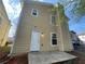 Home exterior features a back patio and a white door at 1374 To Lani Farm Rd, Stone Mountain, GA 30083