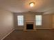 Inviting living area featuring plush carpeting and a cozy fireplace at 1374 To Lani Farm Rd, Stone Mountain, GA 30083