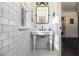 Bright bathroom with white subway tile, pedestal sink, and black and white mosaic tile floor at 2531 Paul Nw Ave, Atlanta, GA 30318