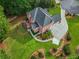 Aerial view of the brick home, mature trees and manicured lawn at 2930 Monticello Dr, Cumming, GA 30041