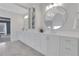 Bright bathroom featuring double vanity with modern fixtures, large mirrors, and marble flooring at 2930 Monticello Dr, Cumming, GA 30041