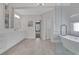 Bright bathroom featuring a glass shower, soaking tub, double vanity, and marble flooring at 2930 Monticello Dr, Cumming, GA 30041
