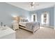 Comfortable bedroom featuring a ceiling fan, soft carpet, and natural light from two windows at 2930 Monticello Dr, Cumming, GA 30041