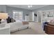 Spacious primary bedroom featuring blue walls, carpet floors, and a window with backyard view at 2930 Monticello Dr, Cumming, GA 30041