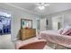 Serene bedroom featuring soft pastel tones, a large dresser, and a walk-in closet for ample storage at 2930 Monticello Dr, Cumming, GA 30041
