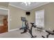 Home gym complete with a stationary bike, weights, and a mounted television for easy workouts at 2930 Monticello Dr, Cumming, GA 30041