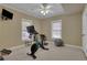 Well-lit home gym area with a stationary bike, workout equipment, and a ceiling fan for a comfortable workout at 2930 Monticello Dr, Cumming, GA 30041