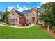 Traditional brick home with manicured landscaping and a lush green lawn at 2930 Monticello Dr, Cumming, GA 30041