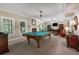 Spacious game room boasts a pool table, fireplace, and cozy seating area, perfect for entertaining and relaxing at 2930 Monticello Dr, Cumming, GA 30041