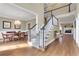 Bright interior showcasing a staircase, dining area with chandelier, and a living room with fireplace at 2930 Monticello Dr, Cumming, GA 30041