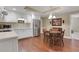 Eat-in kitchen with stainless steel appliances, granite counters, and hardwood floors, plus a four-chair table at 2930 Monticello Dr, Cumming, GA 30041