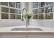 Close-up of a kitchen sink with a stylish faucet and a view of the wooded outdoors at 2930 Monticello Dr, Cumming, GA 30041
