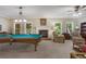 Spacious living room with a pool table, fireplace, and comfortable seating, perfect for entertaining at 2930 Monticello Dr, Cumming, GA 30041