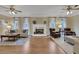 Spacious living room with hardwood floors, a fireplace, and two ceiling fans and ample seating at 2930 Monticello Dr, Cumming, GA 30041