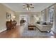 Cozy living room with hardwood floors and view into modern kitchen at 2930 Monticello Dr, Cumming, GA 30041