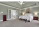 Spacious bedroom with tray ceilings, carpet and ensuite bathroom at 2930 Monticello Dr, Cumming, GA 30041