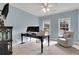 Inviting home office with a comfortable chair, desk, and two windows providing natural light at 2930 Monticello Dr, Cumming, GA 30041