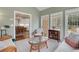Relaxing sunroom with wicker furniture and view into breakfast nook at 2930 Monticello Dr, Cumming, GA 30041