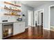 Stylish bar area features a beverage cooler, open shelving, and hardwood floors at 3197 Church St, Atlanta, GA 30344