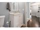 Well-lit bathroom features a single sink vanity, hardwood floors, and easy access to other rooms at 3197 Church St, Atlanta, GA 30344