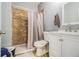 Cozy bathroom features a tiled shower, modern white vanity and a neutral shower curtain at 3197 Church St, Atlanta, GA 30344