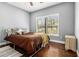 Comfortable bedroom offers a large window, hardwood floors and neutral wall color at 3197 Church St, Atlanta, GA 30344