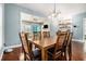 Elegant dining room with hardwood floors, modern lighting, and open access to the living room at 3197 Church St, Atlanta, GA 30344