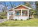 Charming bungalow with a welcoming front porch, wood detail, and manicured lawn at 3197 Church St, Atlanta, GA 30344