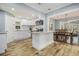 Bright, open kitchen boasts white cabinetry, granite counters, and seamlessly connects to the dining area at 3197 Church St, Atlanta, GA 30344