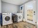 Convenient laundry room equipped with washer, dryer, and storage, leading to the outdoors at 3197 Church St, Atlanta, GA 30344