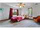 Cozy bedroom featuring neutral walls, bright natural light, and a decorative ceiling fan at 3292 Holly Mill Ct, Marietta, GA 30062